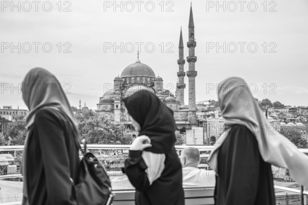 Three muslim women walking through istanbul, admiring the stunning suleymaniye mosque in the background, embracing the city's rich culture