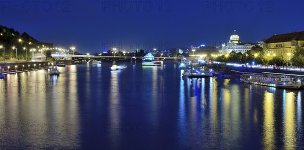 Vltava river reflecting the vibrant cityscape of prague, with boats sailing gracefully on a warm summer night, creating a serene atmosphere
