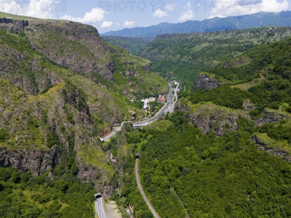 View of valley with roads, tunnels and houses in green mountain landscape, aerial view, landscape near Dzoraget, river Pambak in front of the tunnel, river Debed, gorge Debed, Lorikeet province, Armenia