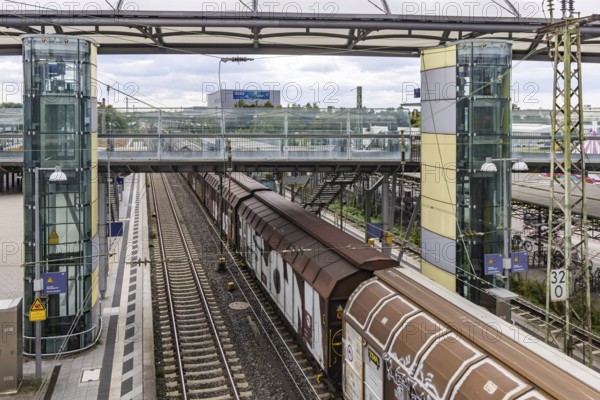 Railway station with passing goods train in Walldorf-Wiesloch. Wiesloch, Baden-Württemberg, Germany