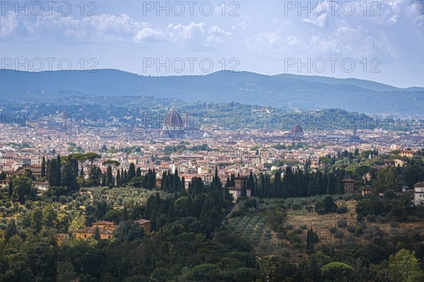 Sweeping views of the city of Florence and cathedral surrounded by Tuscan hills in Italy