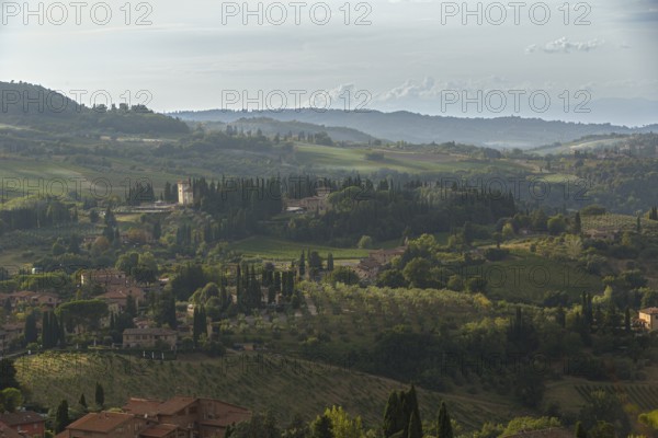 Village and fields in the soft evening light of the Tuscan countryside in San Gimignano, Italy