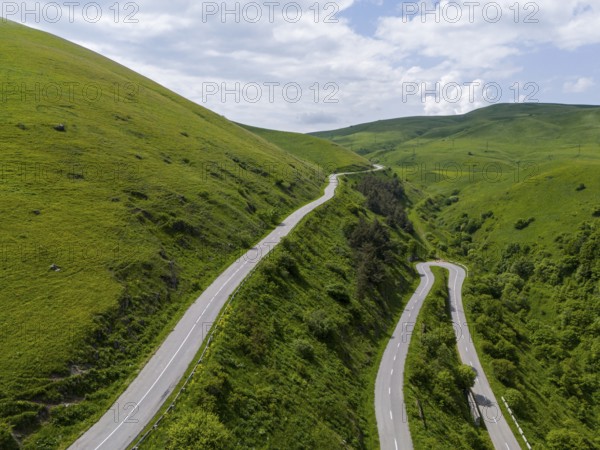 Serpentine road winding through green hills under partly cloudy sky, aerial view, road H52 above a tunnel, Dilijan, Dilijan, Delijan, Delijan, Dilijan National Park, Tavush Province, Tavush, Armenia