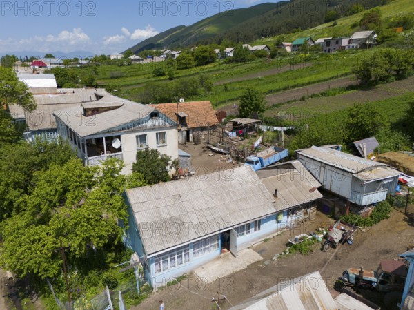 Rural scene with traditional buildings and view of fields and surrounding nature, aerial view, Lermontovo, inhabited by spiritual Christians Pryguny and Molokans from Russia, Lorikeet Province, Armenia
