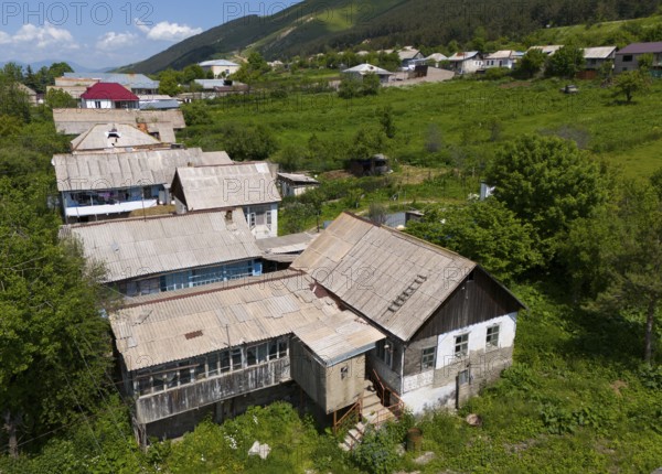 Rustic building ensemble in a rural setting surrounded by nature and green hills, aerial view, Lermontovo, inhabited by spiritual Christians Pryguny and Molokans from Russia, Lorikeet Province, Armenia
