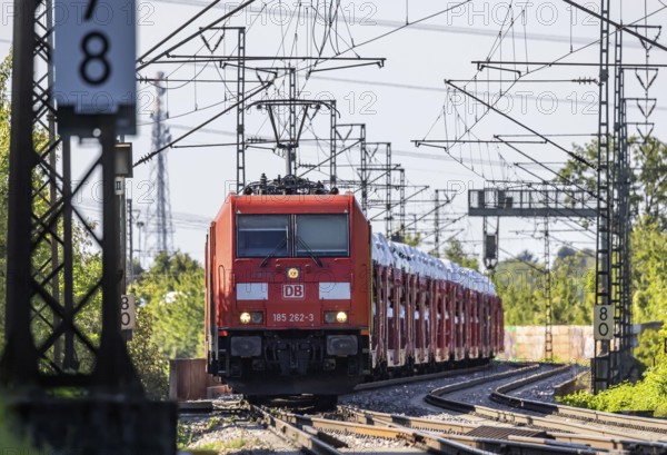 Car train with new cars on the railway line near Stuttgart. The so-called Schusterbahn is a bypass of Stuttgart main station and is mainly used by goods trains. Stuttgart, Baden-Württemberg, Germany