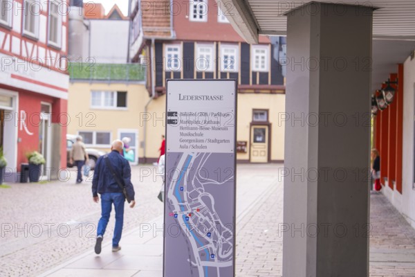 Detailed architecture with half-timbered houses and a walking man, small town of Perle Calw, Black Forest, Germany