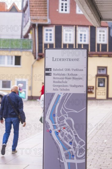 Signpost in a picturesque old town with half-timbered houses in the background, small town pearl Calw, Black Forest, Germany