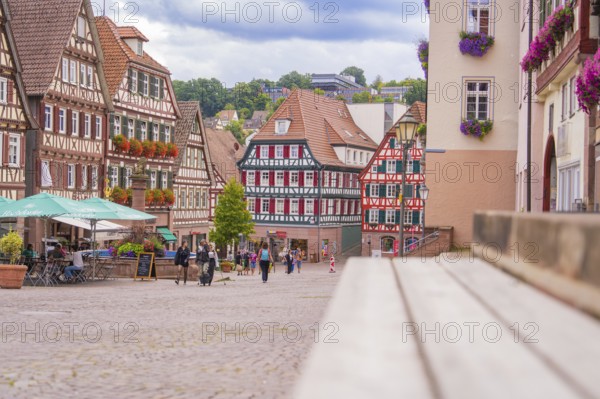 Lively street scene with half-timbered houses and passers-by, small town of Perle Calw, Black Forest, Germany
