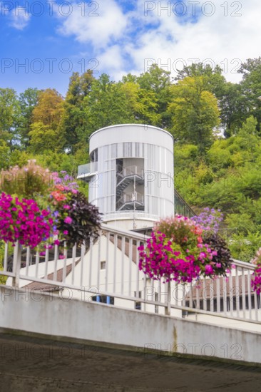 Modern architecture with flowers on a bridge in an urban and green environment, small town of Perle Calw, Black Forest, Germany