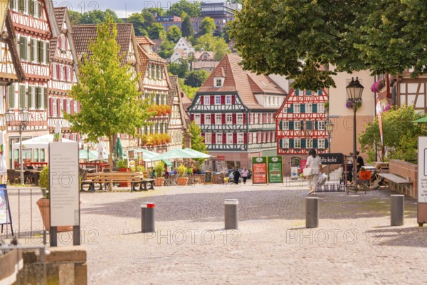 Sunny pedestrian zone with half-timbered houses and inviting café, small town pearl Calw, Black Forest, Germany