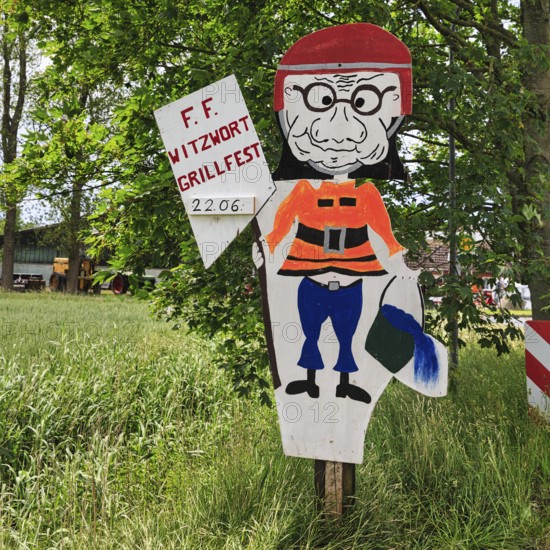 Funny sign with fireman figure and water bucket, inscription, invitation to barbecue, volunteer fire brigade, Witzwort, North Frisia, Schleswig-Holstein, Germany