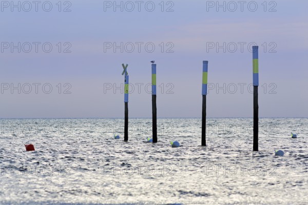 Four poles in a row, marker, sea mark, buoys, evening sky, Sankt Peter-Ording, Eiderstedt peninsula, Wadden Sea National Park, North Sea, North Frisia, Schleswig-Holstein, Germany
