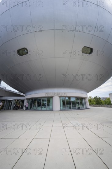 Dome-shaped modern building with prominent entrance area and architectural details, BMW Welt, Munich, Germany