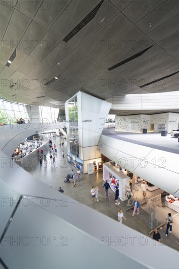 Modern building complex with various shops and numerous visitors, BMW Welt, Munich, Germany