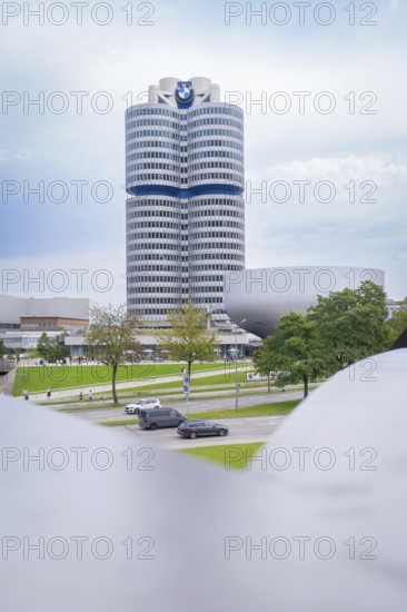 Tall, modern building with striking design and neighbouring green space, BMW Welt, Munich, Germany