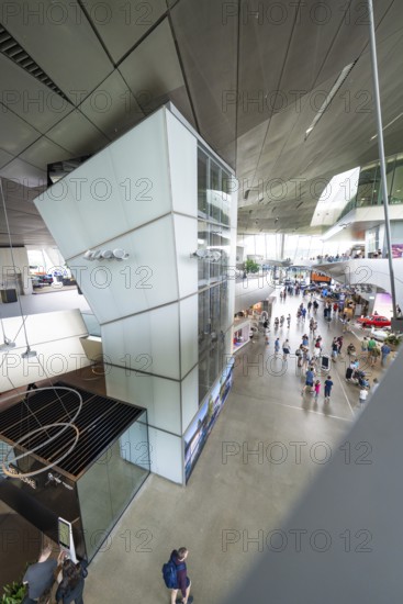 View from above of an exhibition space with many visitors and modern elements, BMW Welt, Munich, Germany