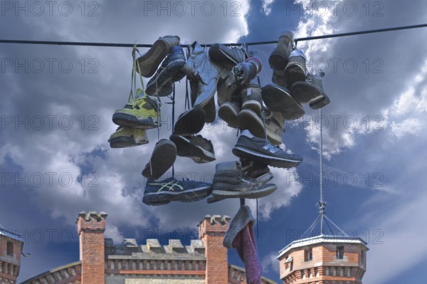 Shoes hanging on a leash in the courtyard of a residential home for addicts, each shoe a reminder of a deceased person, Baden-Württemberg