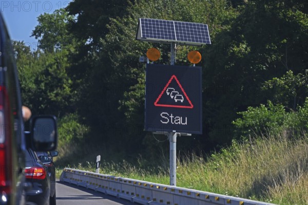 Traffic sign with solar-powered traffic jam warning on the motorway, Baden-Württemberg, Germany