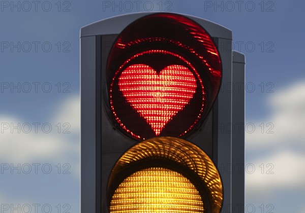 Traffic light with red light in the shape of a heart, Akureyri, North Iceland, Iceland
