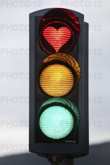 Traffic lights with green light, yellow light and red light in the shape of a heart, symbolic image of traffic light coalition, Akureyri, Iceland