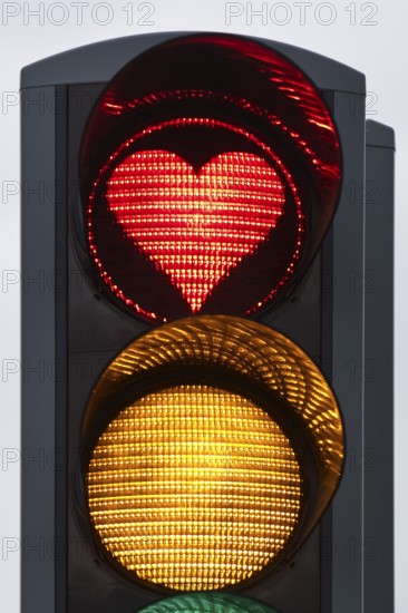 Traffic light with red light in the shape of a heart, Akureyri, North Iceland, Iceland