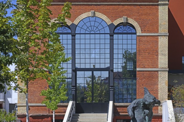 Artist's studio of the artist Stefan Strumbel in a former, historic boiler house of a brewery, in front of it a sculpture by the artist, Offenburg, Baden-Württemberg, Germany