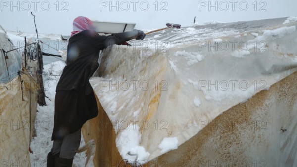 Displaced Syrian families and children living in refugee camps during harsh winter conditions, facing snow, cold weather, and difficult humanitarian circumstances. Aleppo, Syria January 01, 2022, Aleppo, Syria