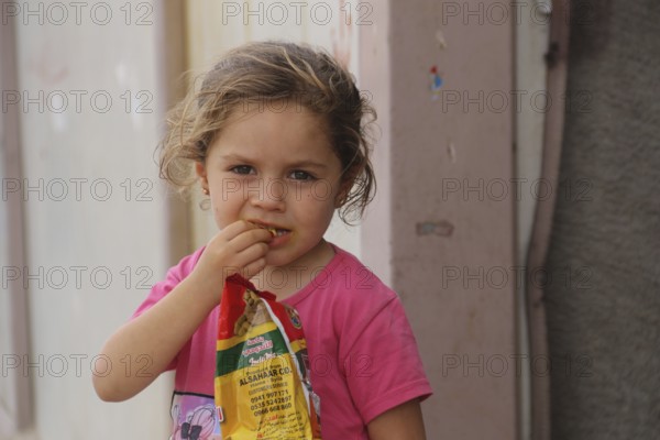 A Syrian refugee child photographed in a camp, reflecting the harsh living conditions of displaced families. Aleppo, Syria March 2, 2017, Aleppo, Syria