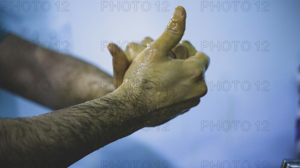 A doctor washing his hands before entering the operating room to perform surgery. Aleppo, Syria October 18, 2022, Aleppo, Syria