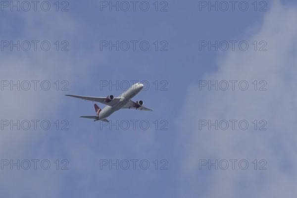Boeing 787 Dreamliner jet passenger aircraft of Virgin Atlantic airlines in flight in a blue sky, England, United Kingdom