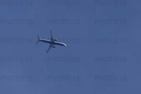 Boeing 737 jet passenger aircraft of Ryanair airlines flying in a blue sky, England, United Kingdom