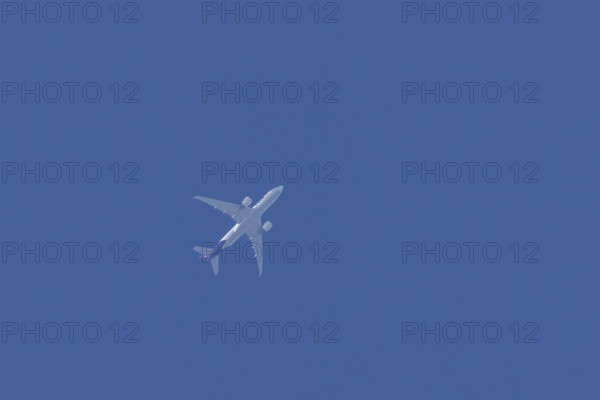 Airbus A300-600RF jet aircraft of FedEx Express airlines in flight in a blue sky, England, United Kingdom