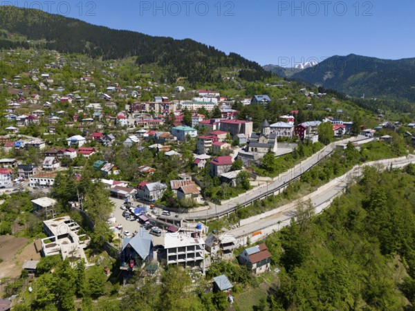 Cityscape embedded in mountains, with colourful houses and lush green surroundings, aerial view, Khulo, Chulo, Autonomous Republic of Adjara, Adjara, Lesser Caucasus, Georgia