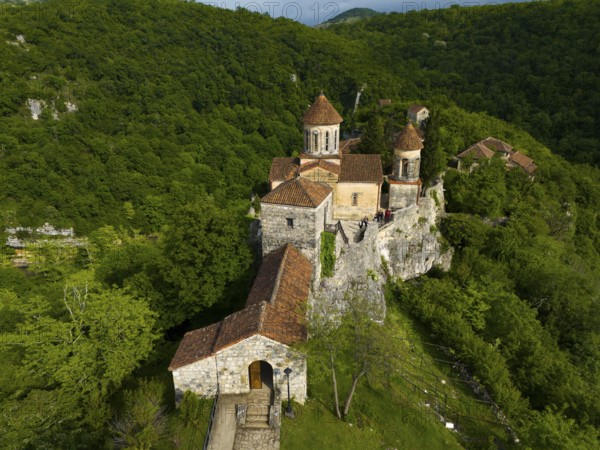Monastery complex on a hill surrounded by a dense forest, aerial view, Motsameta Monastery, near Kutaisi, Imereti region, Georgia