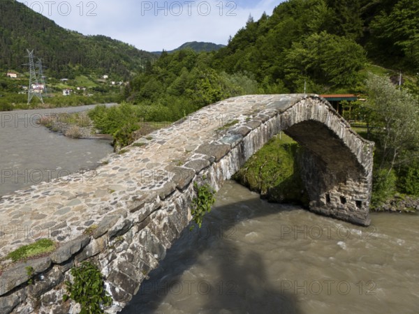 Old stone bridge over a river, embedded in a wooded landscape, aerial view, stone arch bridge Dandalo, Adjaristskali River, Autonomous Republic of Adjara, Adjara, Adjara, Lesser Caucasus, Georgia