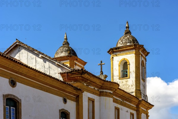 Towers and roof of a historic baroque church in the old city of Ouro Preto