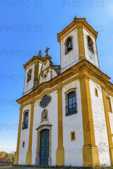 Facade of a baroque church with its towers and crucifix in Ouro Preto, Minas Gerais, Ouro Preto, Minas Gerais, Brazil