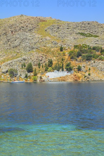 View of the ocean and monastery in the distance from Nimborio Beach, Nimborio, Symi Island, Dodecanese Islands, Greece