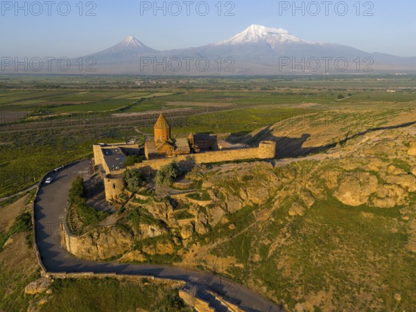 Historic fortress in hilly landscape with mountains in the background, aerial view, Chor Wirap monastery, Chor Virap, deep dungeon, Ararat and Little Ararat in the background, located in Turkey, Ararat province, Armenia