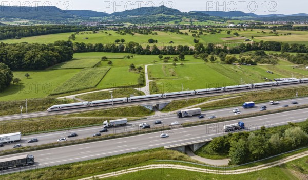 A8 motorway near Kirchheim unter Teck. The route of the new high-speed railway line from Stuttgart to Ulm runs parallel to the road. Deutsche Bahn ICE train. The Swabian Alb with Teck Castle in the background. Kirchheim unter Teck, Baden-Württemberg, Germany