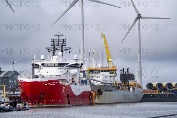 Working vessels in the seaport of Eemshaven, dredger Vitus Bering, aft, cable layer and offshore supply and working vessel Seaway Aimery, Netherlands
