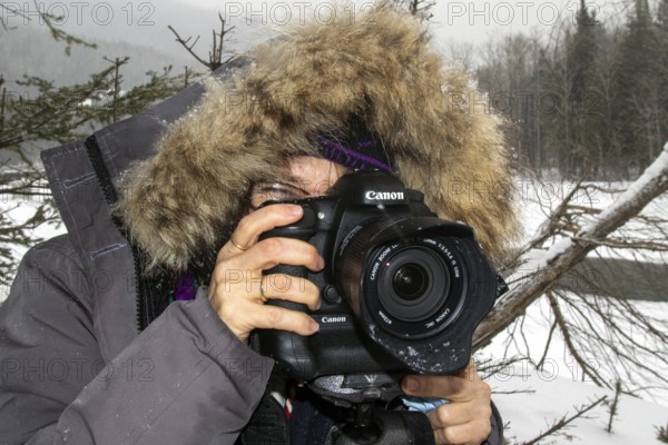 Photographer Veronique Amiard photographs the Ste Anne River in winter, Gaspesie national park, Province of Quebec, Canada, north America
