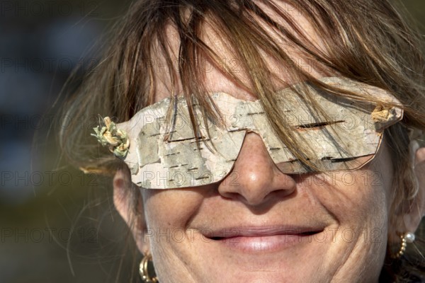 Woman wearing glasses made from birch bark, Gaspesie national park, Province of Quebec, Canada, north America
