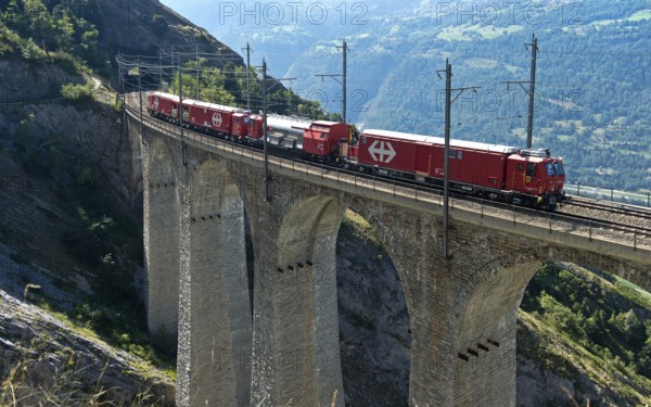 Goods train of the Swiss railway company SBB crosses the Luogelkin Viaduct on the Lötschberg south ramp section near Hohtenn, Valais, Switzerland