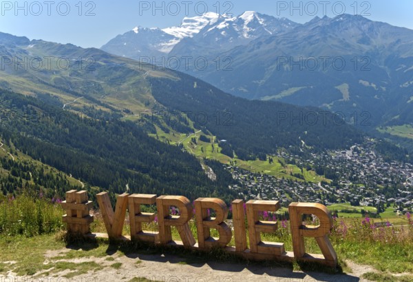 Lettering 'Verbier' in large wooden letters at a photo spot on the Col de la Croix de Cœur pass, Verbier, Valais, Switzerland