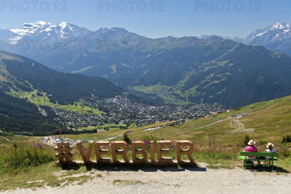 View from the Col de la Croix de Cœur pass to the village of Verbier and the glaciated mountain range of the Grand Combin, Verbier, Valais, Switzerland