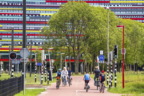 Cycle path through the university campus in Utrecht Science Park, Utrecht University, colourful facade of the Hogeschool Utrecht building, Netherlands