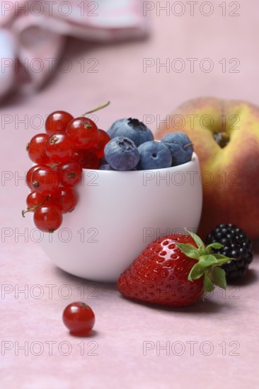 Various fruits in peel, redcurrant, peach, strawberry, blueberry, blackberry