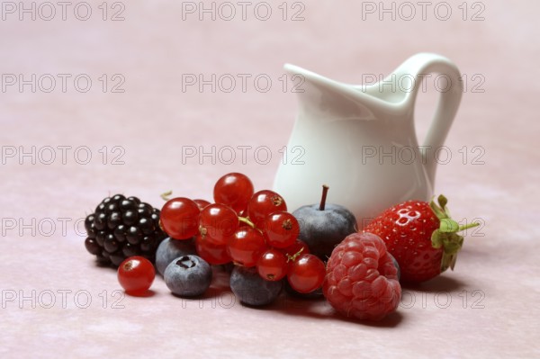 Various fruits with jug, redcurrant, raspberry, strawberry, blueberry, blackberry